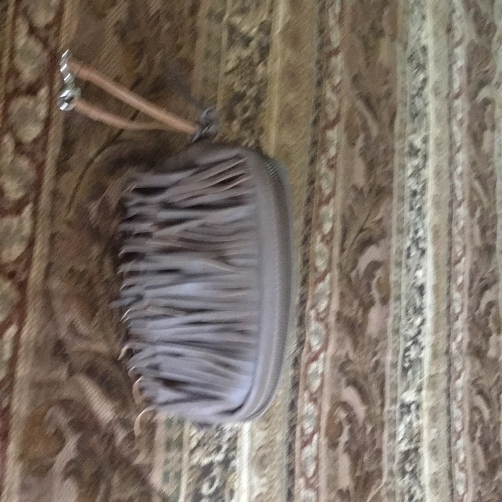 It has frills on front,zipper on top.